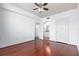 Bright bedroom featuring wood floors, a ceiling fan, and an open doorway to a kitchen area at 300 E South St # 6016, Orlando, FL 32801