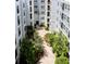 Aerial view of a peaceful courtyard garden surrounded by a modern condominium complex at 300 E South St # 6016, Orlando, FL 32801