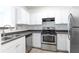 Kitchen features stainless steel appliances and white cabinetry at 300 E South St # 6016, Orlando, FL 32801