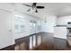 Open-concept living room featuring hardwood floors, a ceiling fan, and balcony access at 300 E South St # 6016, Orlando, FL 32801