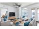 Staged living room with hardwood floors, ceiling fan, and a balcony overlooking the neighborhood at 300 E South St # 6016, Orlando, FL 32801