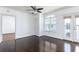 This is a bright, open-concept living room with hardwood floors and a ceiling fan at 300 E South St # 6016, Orlando, FL 32801