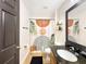 Renovated bathroom with decorative shower curtain, shelving, and elegant vanity at 3101 Linton Rd, Kissimmee, FL 34758