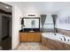 Bright bathroom featuring a soaking tub, natural wood cabinetry, and black granite countertop at 3101 Linton Rd, Kissimmee, FL 34758