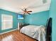Light filled bedroom with ceiling fan, hardwood floors and calming blue paint at 3101 Linton Rd, Kissimmee, FL 34758