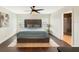 Cozy bedroom featuring neutral tones, a ceiling fan, hardwood floors, and ample natural light at 3101 Linton Rd, Kissimmee, FL 34758