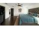 Spacious bedroom featuring hardwood floors, a ceiling fan, and a walk-in closet, offering a peaceful retreat at 3101 Linton Rd, Kissimmee, FL 34758