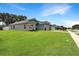 Well-maintained single-story home featuring a spacious green lawn and a side view of the property at 3101 Linton Rd, Kissimmee, FL 34758