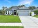 Charming single-story home with a well-manicured lawn, a two-car garage, and tasteful landscaping at 3101 Linton Rd, Kissimmee, FL 34758