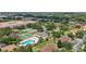 Overhead view showcasing community tennis courts and pool, nestled among mature trees and well-maintained apartment buildings at 3118 S Semoran Blvd # 2, Orlando, FL 32822
