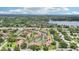Scenic aerial of the condominium community highlighting roadway access, lush greenery and a lake nearby at 3118 S Semoran Blvd # 2, Orlando, FL 32822