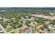 Aerial view of a community featuring a pool, tennis courts, lush trees and multiple condominium buildings at 3118 S Semoran Blvd # 2, Orlando, FL 32822
