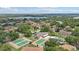 Scenic aerial view of a community featuring tennis courts and a refreshing pool, surrounded by lush landscaping at 3118 S Semoran Blvd # 2, Orlando, FL 32822