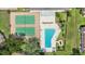 Aerial shot of a community pool with lounge chairs and tennis courts, perfect for recreation and relaxation at 3118 S Semoran Blvd # 2, Orlando, FL 32822
