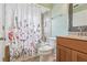 Updated bathroom features a shower-tub combo with a floral shower curtain and a modern vanity at 3118 S Semoran Blvd # 2, Orlando, FL 32822