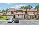 Exterior of a two story condo with parking spaces and two palm trees at 3118 S Semoran Blvd # 2, Orlando, FL 32822