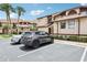 Townhome with assigned parking features a well-maintained facade, landscaping and proximity to community amenities at 3118 S Semoran Blvd # 2, Orlando, FL 32822