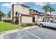 Inviting townhome complex featuring neutral color scheme, lush landscaping, and convenient parking at 3118 S Semoran Blvd # 2, Orlando, FL 32822