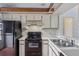 This kitchen features white cabinets, laminate counters, and black appliances at 3118 S Semoran Blvd # 2, Orlando, FL 32822
