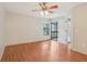 Bright, open living room with hardwood floors and access to the outdoors through a screened patio at 3118 S Semoran Blvd # 2, Orlando, FL 32822