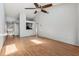 A spacious living room featuring light gray walls, laminate flooring, and vaulted ceilings at 3118 S Semoran Blvd # 2, Orlando, FL 32822