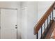 Entryway view of a stairway with wood and black metal railings and white doors at 3118 S Semoran Blvd # 2, Orlando, FL 32822