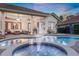 The back patio features an outdoor kitchen and comfortable seating area with beautiful pool views at 3316 Regal Crest Dr, Longwood, FL 32779