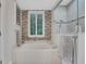 A beautiful bathtub is accented by tile walls and white shuttered windows at 3316 Regal Crest Dr, Longwood, FL 32779