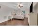 Neutral bedroom boasts hardwood floors, a ceiling fan, and a sunny window at 3316 Regal Crest Dr, Longwood, FL 32779