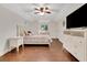 Comfortable bedroom features modern furnishings, hardwood floors, and a tray ceiling at 3316 Regal Crest Dr, Longwood, FL 32779
