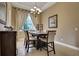 Cozy dining room featuring a chandelier, and a large window with elegant curtains at 3316 Regal Crest Dr, Longwood, FL 32779