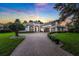 Stunning exterior view of luxury home showcasing the beautiful brick driveway and meticulous landscaping at 3316 Regal Crest Dr, Longwood, FL 32779