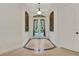 Elegant foyer featuring decorative double doors, tile flooring, and arched transom windows at 3316 Regal Crest Dr, Longwood, FL 32779