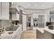 Modern kitchen boasts stainless steel appliances, white cabinetry, and a gray tile backsplash at 3316 Regal Crest Dr, Longwood, FL 32779