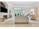 Bright living room featuring a stone fireplace, built-in bar, and access to the outdoor space at 3316 Regal Crest Dr, Longwood, FL 32779
