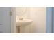 Pedestal sink with brushed nickel faucet in bright half-bathroom at 3569 Seneca Club Loop # 13, Orlando, FL 32808