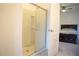 Bathroom featuring a walk-in shower with glass door, and adjacent main bedroom in the background at 3569 Seneca Club Loop # 13, Orlando, FL 32808