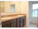 Spacious bathroom with double sinks, a full mirror, and dark brown cabinetry at 3569 Seneca Club Loop # 13, Orlando, FL 32808