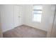 This bedroom offers ample space with a window, closet, and neutral carpet at 3569 Seneca Club Loop # 13, Orlando, FL 32808