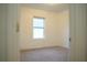 Cozy bedroom with a bright window, neutral carpet, and freshly painted walls at 3569 Seneca Club Loop # 13, Orlando, FL 32808