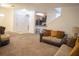 Open-concept living room with neutral colors, large sofa, and seamless flow to the kitchen at 3569 Seneca Club Loop # 13, Orlando, FL 32808