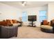 Spacious living room filled with light features plush furnishings and ceiling fan for comfort at 3569 Seneca Club Loop # 13, Orlando, FL 32808