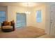 Bright living room featuring carpet flooring, a chandelier, and sliding glass doors to a backyard view at 3569 Seneca Club Loop # 13, Orlando, FL 32808