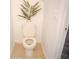 Close-up of a toilet with leafy green plant decoration at 3569 Seneca Club Loop # 13, Orlando, FL 32808