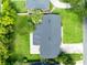 Aerial view of the house with manicured lawn and surrounding greenery at 4006 Kasper Dr, Orlando, FL 32806