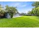Spacious backyard featuring lush greenery and a well-maintained lawn at 4006 Kasper Dr, Orlando, FL 32806