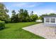 Expansive backyard with healthy green grass and a brick patio area at 4006 Kasper Dr, Orlando, FL 32806