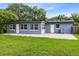 Backyard with a well-maintained lawn and a brick patio at 4006 Kasper Dr, Orlando, FL 32806