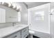Bathroom features a modern vanity, sink, and bathtub-shower combo with white tiling at 4006 Kasper Dr, Orlando, FL 32806
