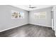 Sunlit bedroom features modern ceiling fan and large windows that bring the outdoor in at 4006 Kasper Dr, Orlando, FL 32806